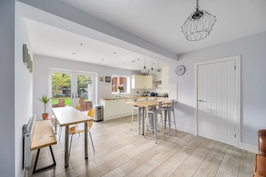 Bright kitchen diner with a breakfast bar and doors to the garden